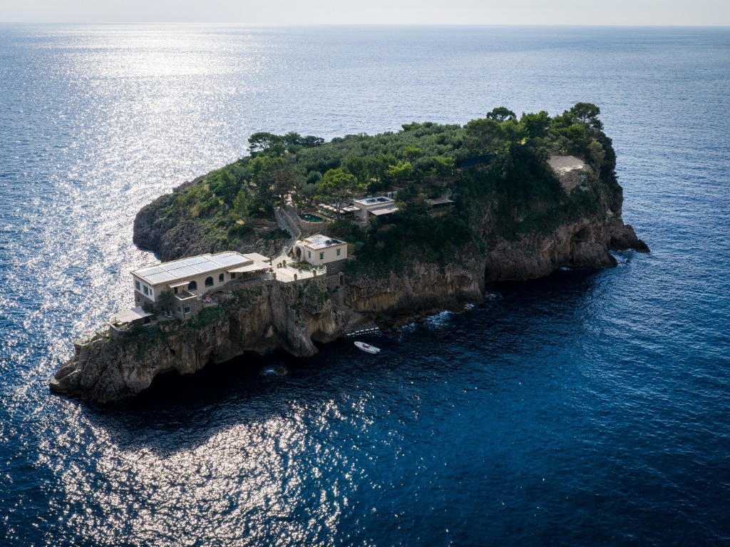 Aerial view of a private Caribbean island showing docking channels and villa estates