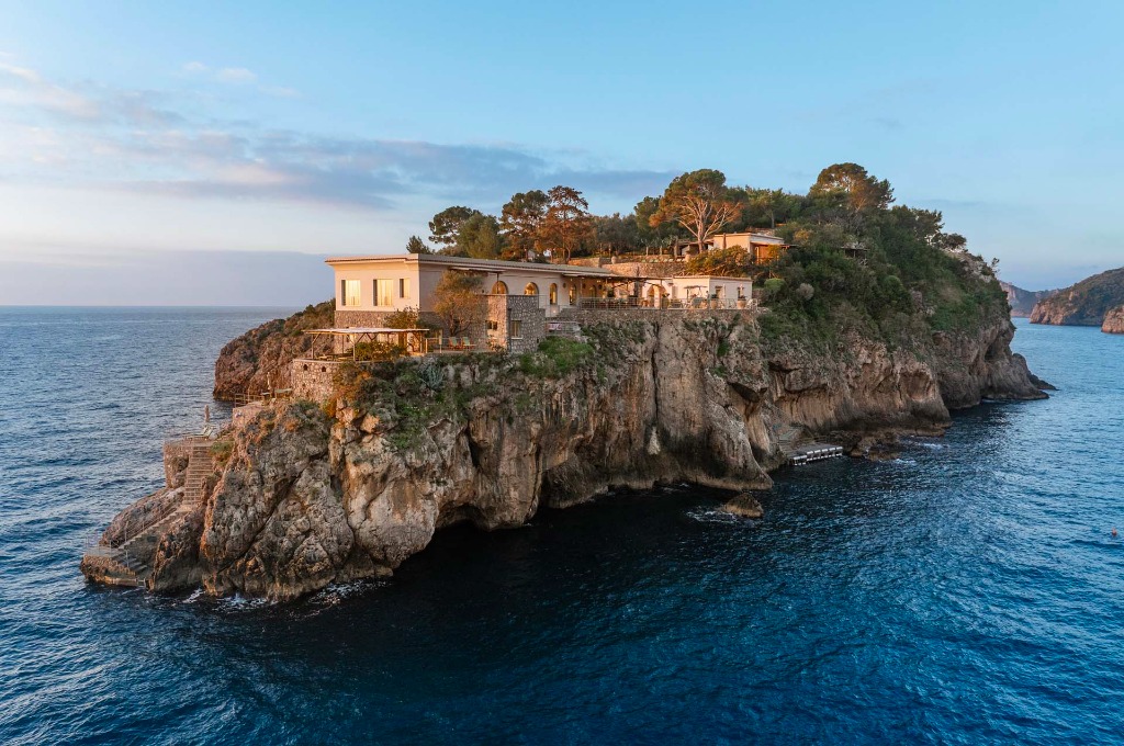 Ultra-luxury beachfront villa estate perched on a rocky private island cliff