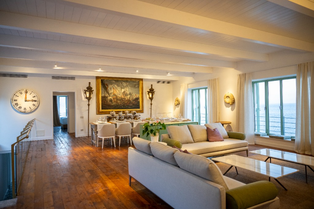 Sophisticated beachfront living room interior of an executive private island villa with direct sea views